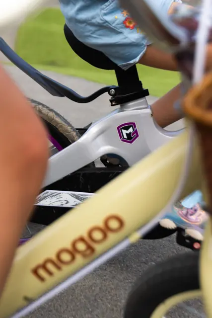 Close-up of the Mogoo logo on a kids bike frame